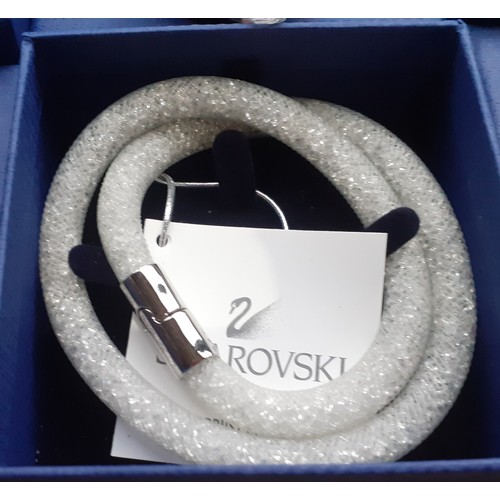 30 - Swarovski-A group of 6 boxed Stardust double bracelets in the following colours pink, copper, silver... 