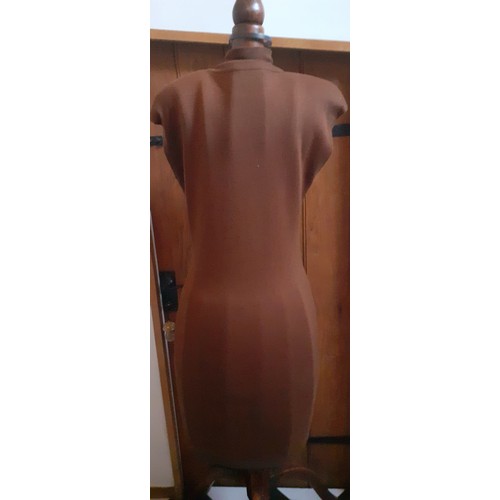 5 - Gucci- A 1980's ladies brown knitted woollen, sleeveless dress A/F, having a turtle neck, padded sho... 