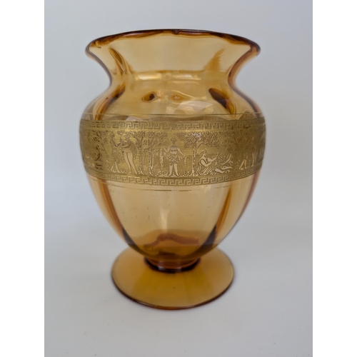 106A - A Val St Lambert amber coloured glass vase decorated in gilt with a repeated classical scene, signed... 