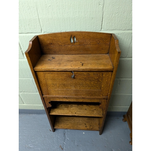 62A - An Arts and Crafts oak student bureau with a pierced gallery, with a fall front enclosing fitted int... 