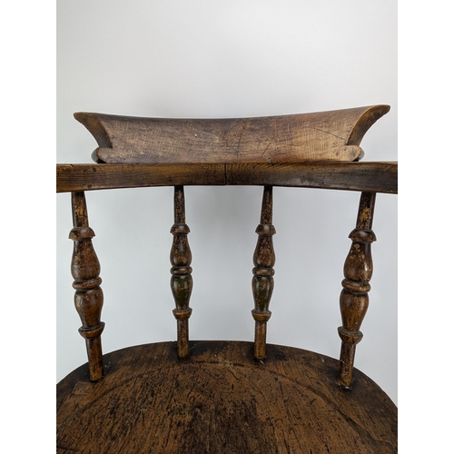 74A - An early 20th century beech and elm smokers bow chair, with a spindle back and turned legs

Location... 