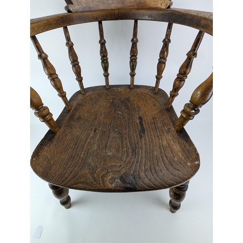 74A - An early 20th century beech and elm smokers bow chair, with a spindle back and turned legs

Location... 