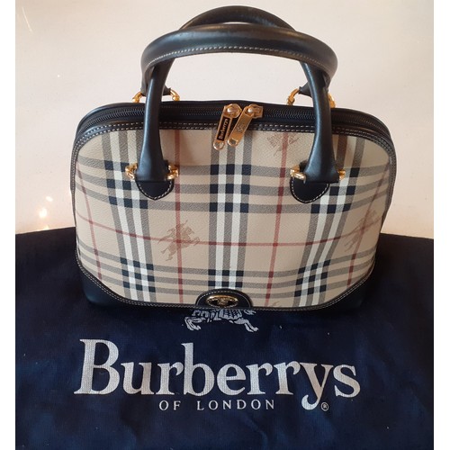 Burberrys- A vintage Haymarket check and black leather Alma handbag, made in Italy, having gold tone hardware, a full length zipper from side to side, a detachable shoulder strap and navy branded dust bag. Location:R2.1
Condition:As new, lining clean, older Burberrys bags do not have a serial number