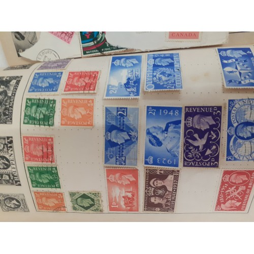 492 - A vintage collection of stamps in stock books, on franked envelopes, loose and in albums to include ... 