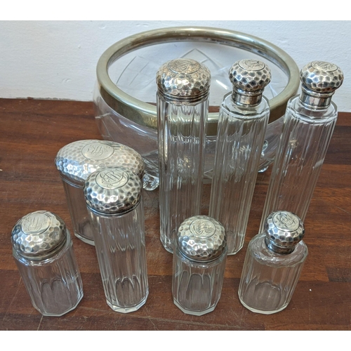 464 - An EPNS rimmed bowl and eight glass jars, all with silver cups/lids Location: LWB
If there is no con... 