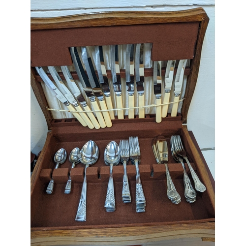 469 - A Viners silver plated canteen of cutlery in a mahogany finished case, and another with additional K... 