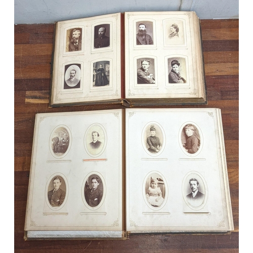 518 - Two Victorian leather bound photo albums, with elaborately decorated covers and some photos surround... 