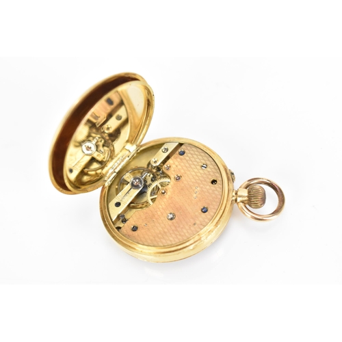 11 - An early 20th century 18ct gold, open face, keyless wound fob watch, the gilt dial having a floral e... 