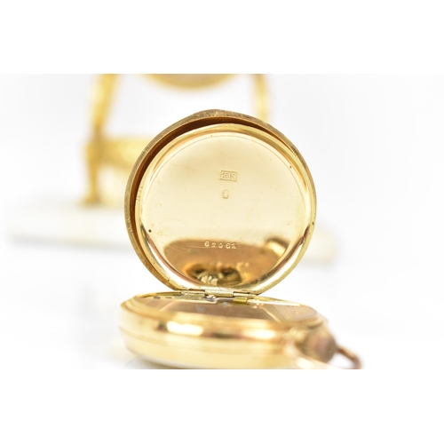 11 - An early 20th century 18ct gold, open face, keyless wound fob watch, the gilt dial having a floral e... 