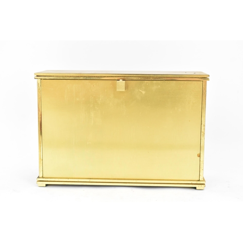 12 - A Jaeger LeCoultre gilt metal table clock, circa 1950s, of rectangular form, the case with red lacqu... 