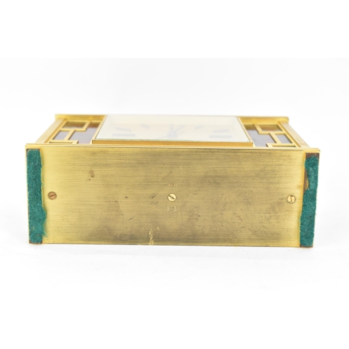 12 - A Jaeger LeCoultre gilt metal table clock, circa 1950s, of rectangular form, the case with red lacqu... 