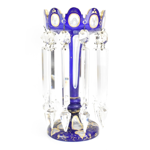 151 - A late 19th Century Bohemian blue overlay clear glass lustre vase, having a scalloped lobed bowls, g... 