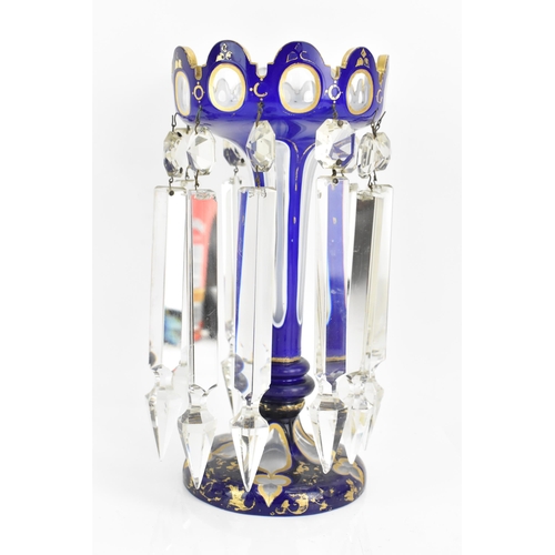 151 - A late 19th Century Bohemian blue overlay clear glass lustre vase, having a scalloped lobed bowls, g... 