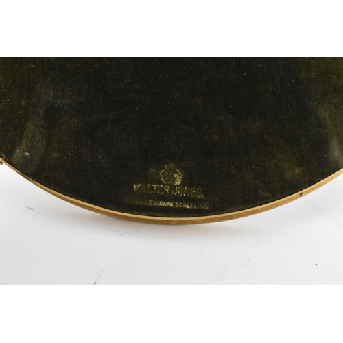 152 - An early 20th century gilt metal oval photograph frame, retailed by Walter Jones, having a reeded fr... 