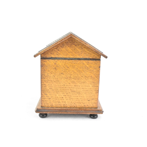 159 - An early 20th century oak novelty cigar and music box, in the form of a kennel with patinated metal ... 