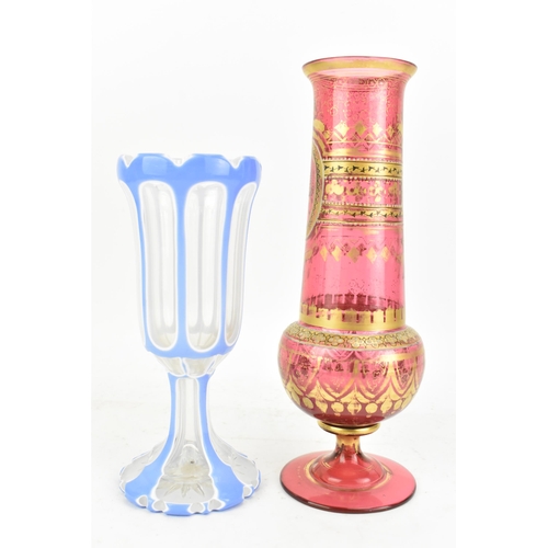 160 - A late 19th century Bohemian cranberry glass vase, having a tapering neck with, knopped stem and tur... 