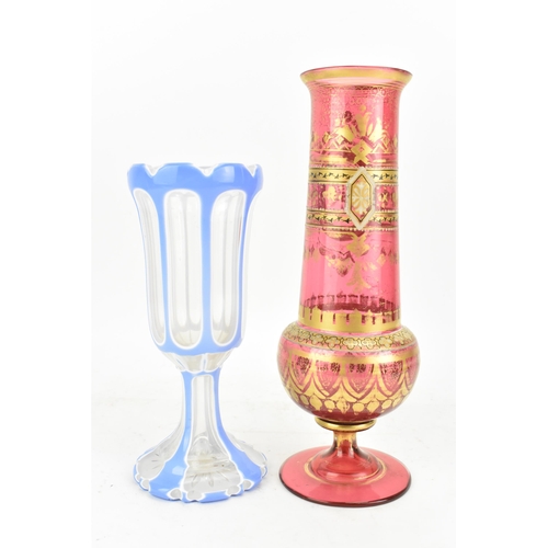 160 - A late 19th century Bohemian cranberry glass vase, having a tapering neck with, knopped stem and tur... 