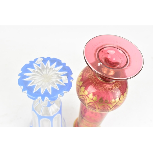 160 - A late 19th century Bohemian cranberry glass vase, having a tapering neck with, knopped stem and tur... 