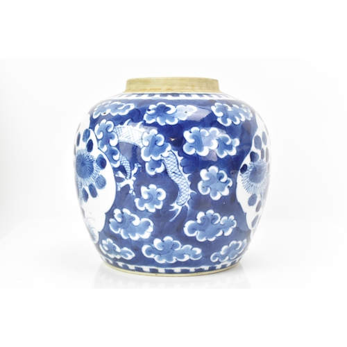 183 - A Chinese late Qing dynasty blue and white ginger jar, late 19th century, painted with a dragon amon... 