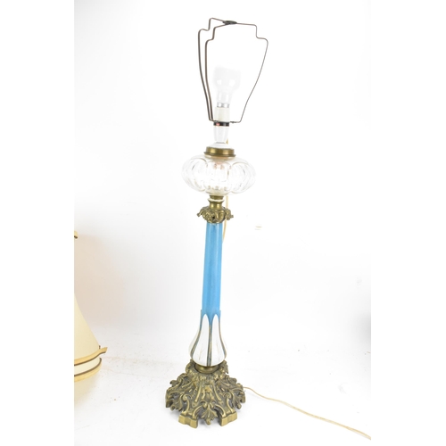 189 - A Victorian gilt brass mounted blue opaline glass table lamp, converted from an oil lamp, having a c... 