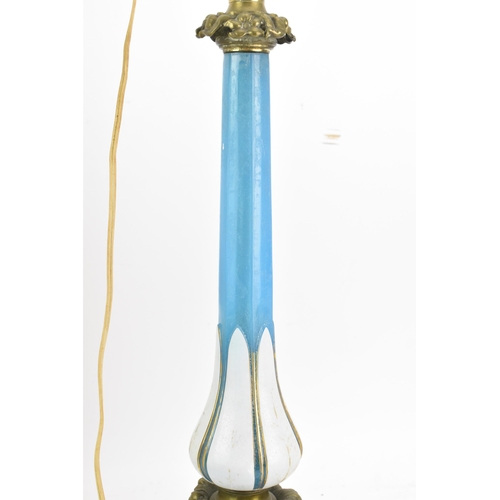 189 - A Victorian gilt brass mounted blue opaline glass table lamp, converted from an oil lamp, having a c... 