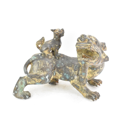 195 - A Chinese large bronzed pottery sculpture of a standing temple foo dog with a pup standing on its ba... 