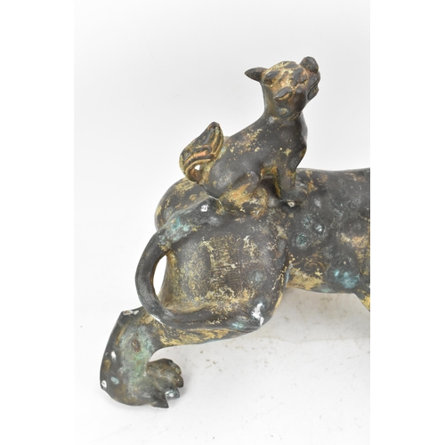 195 - A Chinese large bronzed pottery sculpture of a standing temple foo dog with a pup standing on its ba... 