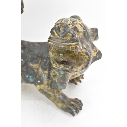 195 - A Chinese large bronzed pottery sculpture of a standing temple foo dog with a pup standing on its ba... 