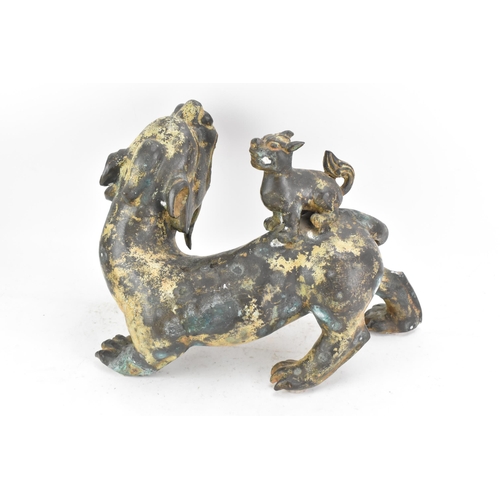 195 - A Chinese large bronzed pottery sculpture of a standing temple foo dog with a pup standing on its ba... 