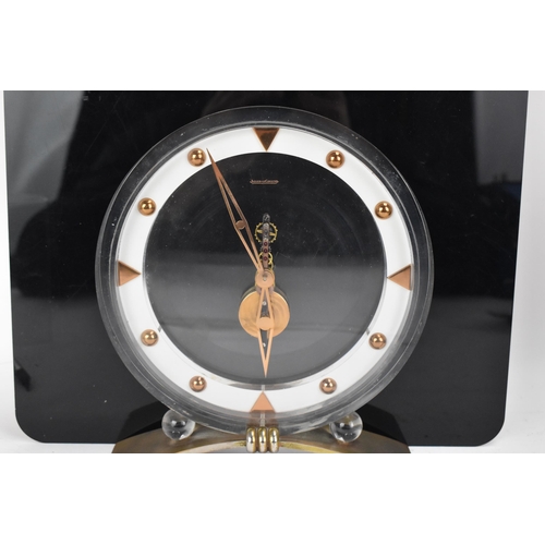 54 - A 1960's Jaeger LeCoultre floating skeleton clock, having a perspex case with visible 8-day movement... 