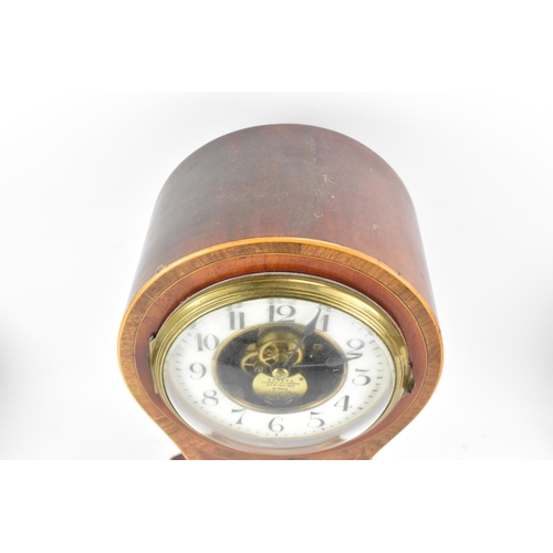 56 - An early 20th century Eureka electric mahogany cased mantle clock, the enamel dial having Arabic num... 