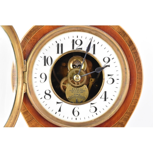 56 - An early 20th century Eureka electric mahogany cased mantle clock, the enamel dial having Arabic num... 