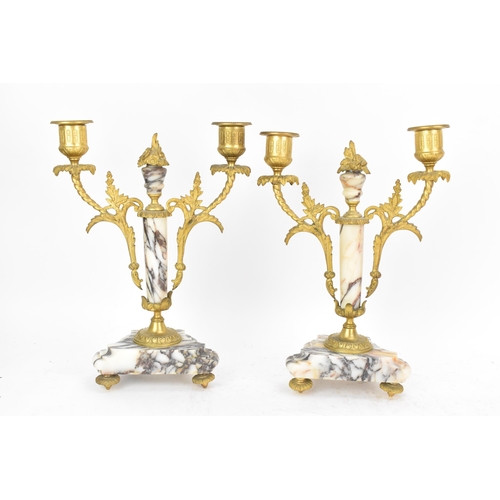 58 - A late 19th century French marble and gilt metal clock garniture, the clock or architectural form wi... 