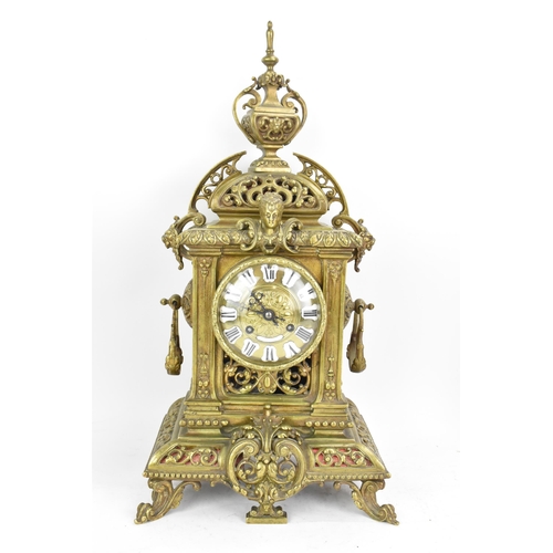 60 - A late 19th century French gilt metal 8 day mantle clock with two spelter figural garnitures, the cl... 