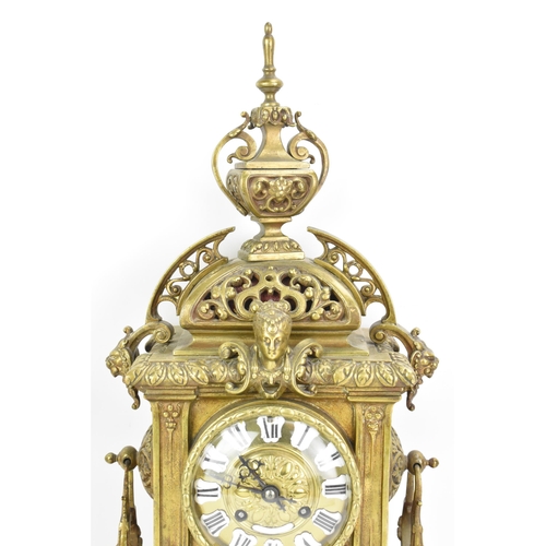 60 - A late 19th century French gilt metal 8 day mantle clock with two spelter figural garnitures, the cl... 