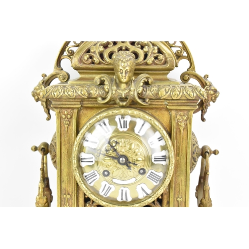 60 - A late 19th century French gilt metal 8 day mantle clock with two spelter figural garnitures, the cl... 