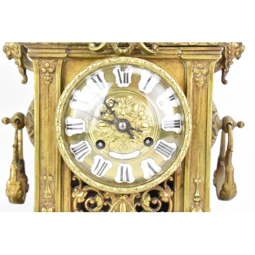 60 - A late 19th century French gilt metal 8 day mantle clock with two spelter figural garnitures, the cl... 