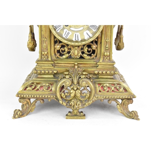 60 - A late 19th century French gilt metal 8 day mantle clock with two spelter figural garnitures, the cl... 