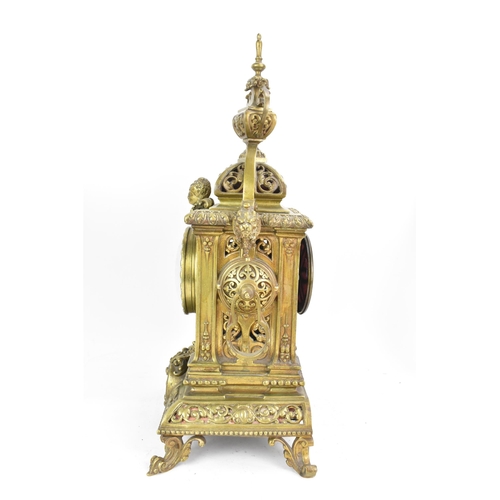 60 - A late 19th century French gilt metal 8 day mantle clock with two spelter figural garnitures, the cl... 