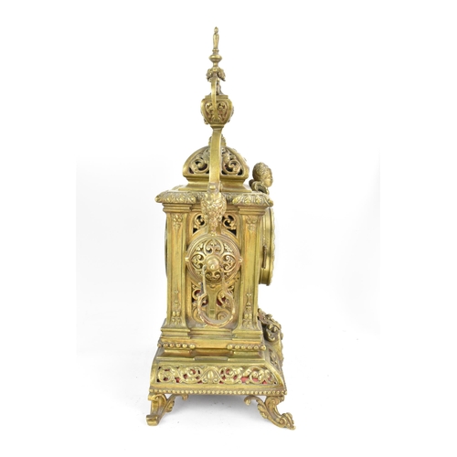 60 - A late 19th century French gilt metal 8 day mantle clock with two spelter figural garnitures, the cl... 