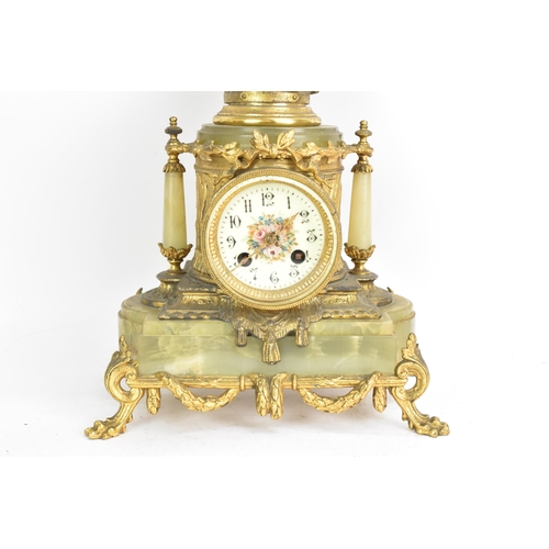 62 - A late 19th century French spelter and onyx mantle clock, mounted with a classical maiden above ribb... 