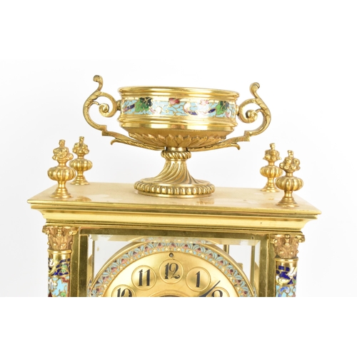 63 - A circa 1900 French gilt metal and cloisonne mantle clock, having a twin scroll handled urn formed f... 