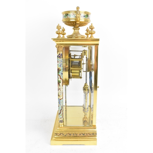 63 - A circa 1900 French gilt metal and cloisonne mantle clock, having a twin scroll handled urn formed f... 