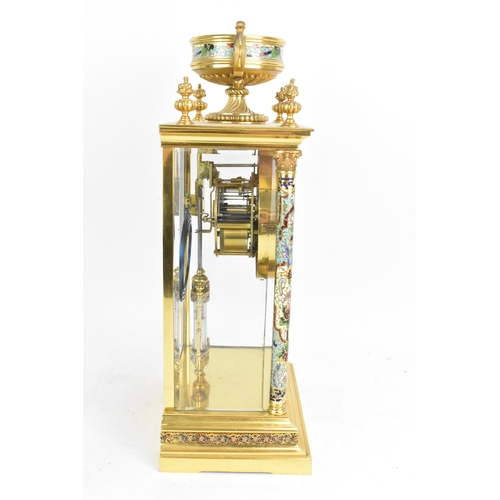 63 - A circa 1900 French gilt metal and cloisonne mantle clock, having a twin scroll handled urn formed f... 