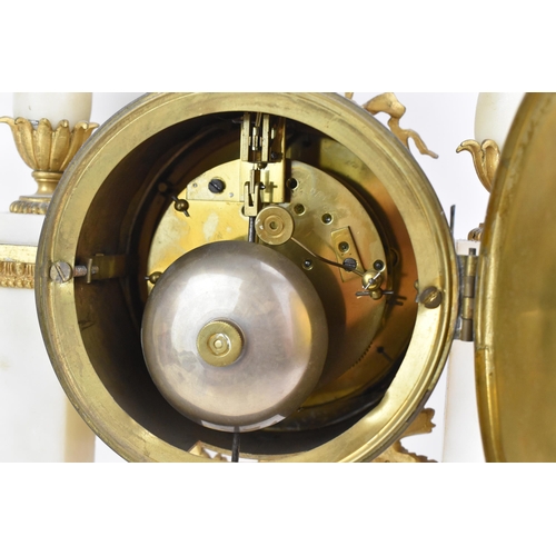 64 - A late 19th century French gilt metal and white marble portico clock and two garnitures, the clock h... 