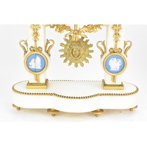 64 - A late 19th century French gilt metal and white marble portico clock and two garnitures, the clock h... 