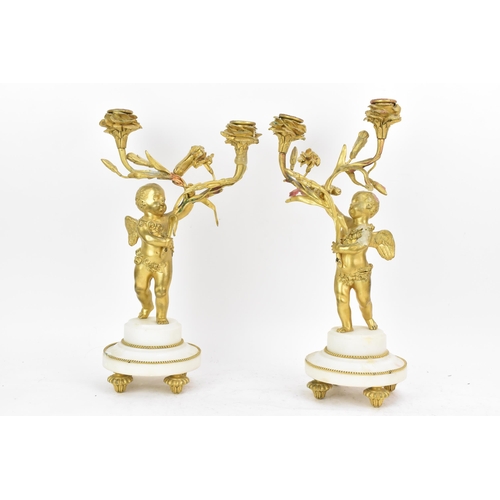 65 - A 19th century French gilt metal and white marble clock garniture, the clock cast as a cherub amongs... 