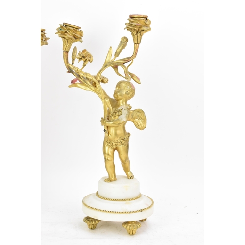 65 - A 19th century French gilt metal and white marble clock garniture, the clock cast as a cherub amongs... 