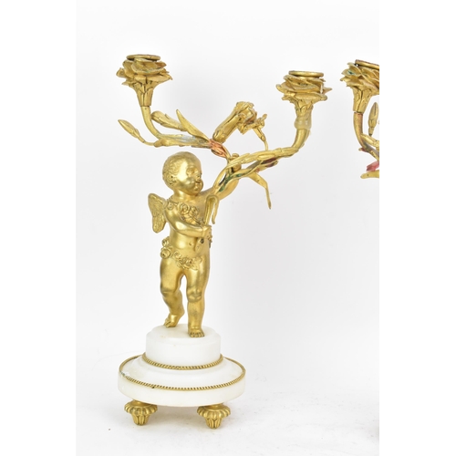 65 - A 19th century French gilt metal and white marble clock garniture, the clock cast as a cherub amongs... 