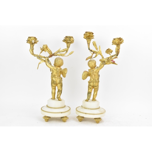 65 - A 19th century French gilt metal and white marble clock garniture, the clock cast as a cherub amongs... 